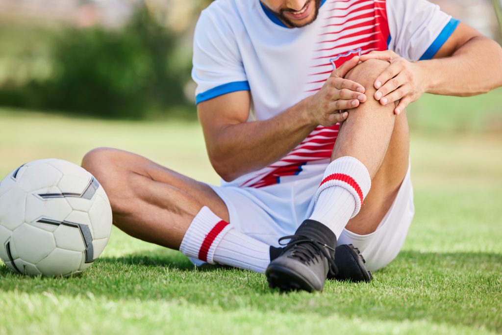 Athlete having sports injury in knee joint